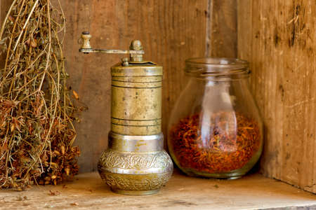 Vintage manual spice grinder on wooden backgroundの写真素材