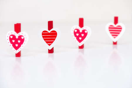 Heart shaped clothes pegs in a rowの写真素材