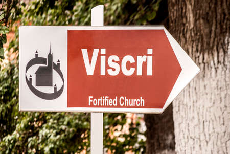 Information board indicating the direction to a fortified churchのeditorial素材