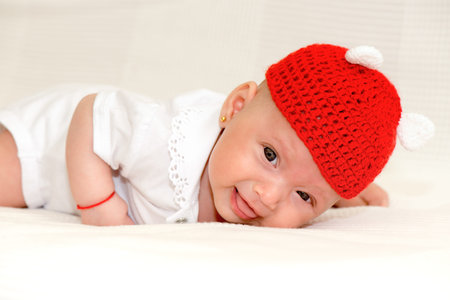 Baby girl portrait with red hat on white background