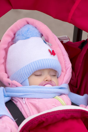 Muffled baby sleeping with dummy in mouth