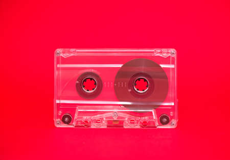 Audio tape on red background conceptual imageの写真素材