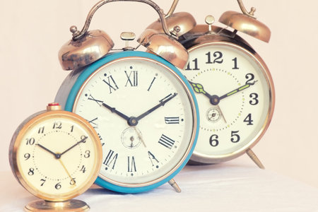 Three vintage alarm clock of different sizes