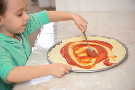 Caucasian girl preparing homemade pizza, conceptual shotの写真素材