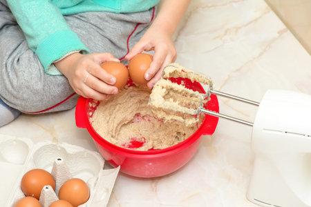 Child prepares dessert in the kitchen, detail