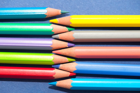Arrangement of crayons on blue background