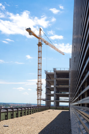 Construction site with crane against blue sky