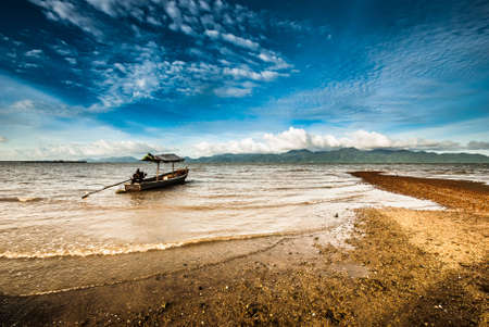 Fishing boat parking opposite the islandの写真素材