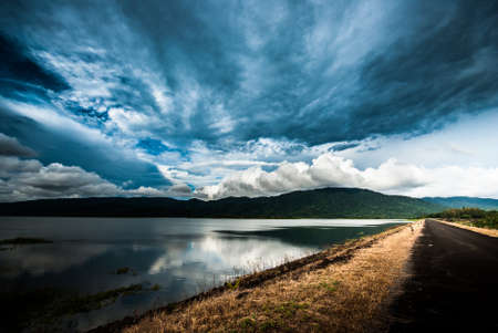 Road on the dam and blue skyの写真素材