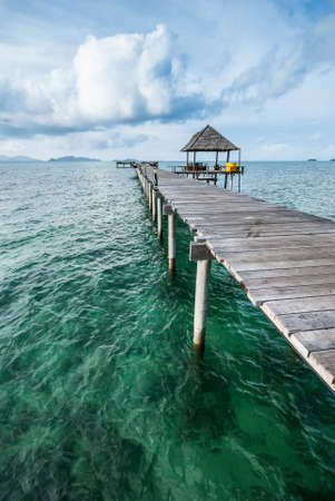 Wooden bridge extending into the seaの写真素材
