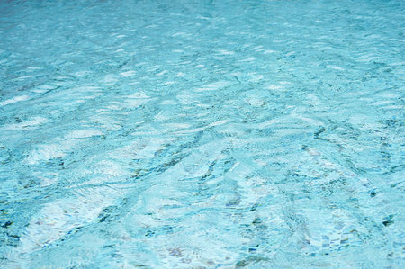 light blue water surface at swimming poolの写真素材