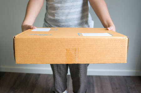woman is sending a boxの写真素材
