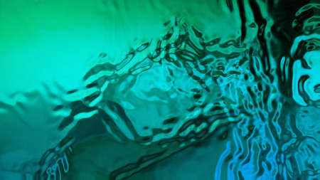 Turquoise background with liquid textures. Beautiful wavy abstraction with smooth lines. Vibration on the liquid.の写真素材