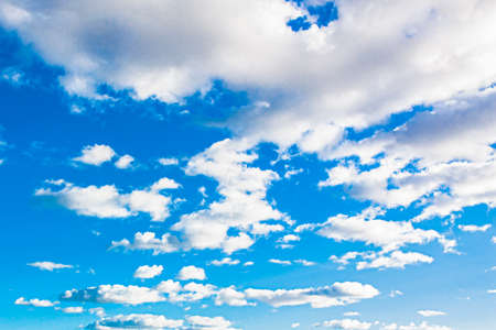 White clouds in a bright, blue sky.の写真素材