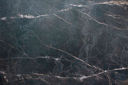 A dark, marble wall with stripes. Black background with marble texture.の写真素材