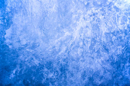An old, blue, concrete wall with scuffs and damage. Cold, blue background with concrete texture.の写真素材