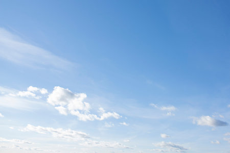 High, fluffy clouds against the blue sky. Beautiful view of clear sky.