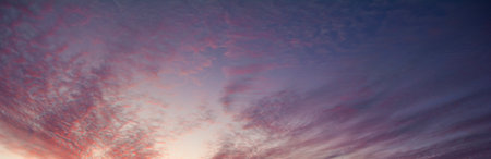Evening clouds in the blue sky. Sky background with blue and purple shades.の写真素材