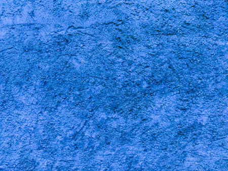 An old, blue cement wall. Blue, stone background. Concrete texture.の写真素材