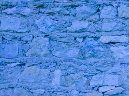 An old, blue stone wall. Blue, stone background. Stone texture.の写真素材