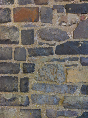 An old gray stone wall. Gray stone background. Brick texture. Brickwork. Vertical image.の写真素材