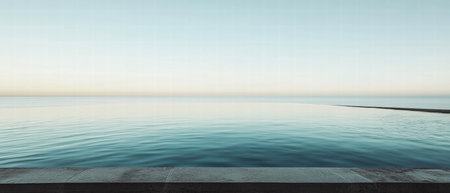 Infinity pool edge meeting calm ocean horizon under clear skies at dawnの素材