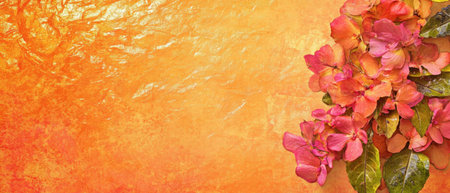 Bright handmade paper featuring vibrant pressed flowers in warm tonesの素材