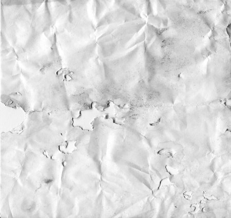 White dipped paper with holes. Texture of damaged old paper.の写真素材