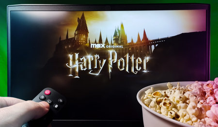 Kyiv. Ukraine. 12/11/2023: Person watching the Harry Potter series on HBO Max with popcorn and a...