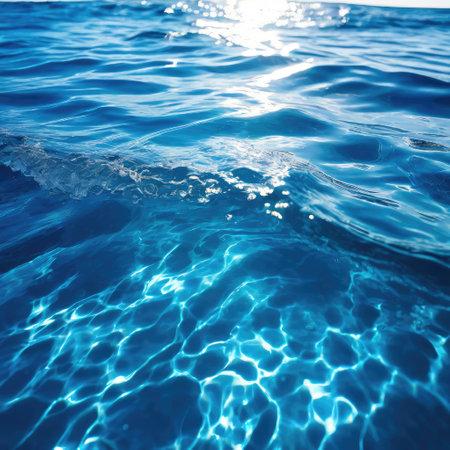 Blue water rippled with sun reflection. Water surface background.の素材