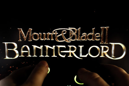 A gamer plays Mount and Blade II Bannerlord with a gamepad. Stock editorial photo with the game...