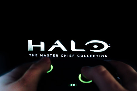 A gamer plays Halo with a gamepad. Stock editorial photo with the game logo. Ukraine, Kiev. 04.14. 2024のeditorial素材