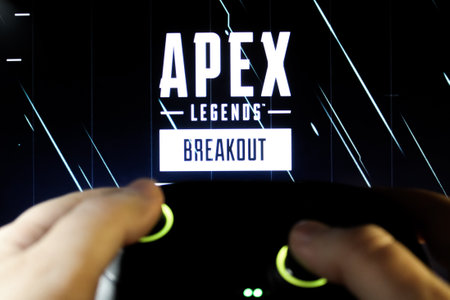 A gamer plays Apex Legends breakout with a gamepad. Stock editorial photo with the game logo. Ukraine, Kiev. 04.14. 2024のeditorial素材