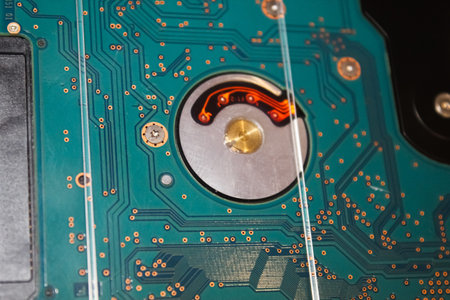 An intricate electronic circuit board with detailed copper traces and a prominent processing area...