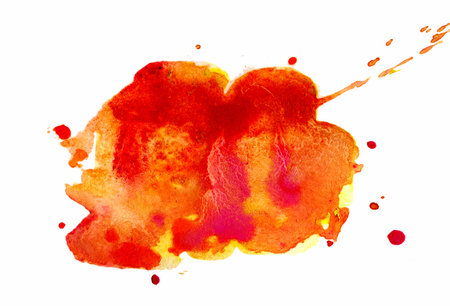 A striking burst of orange and red watercolor captivates with its fluidity, showcasing an energetic blend of colors that evoke feelings of warmth and creativity against a pristine white backdrop.の写真素材