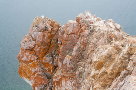 A high rocky coastline a cliff in the sea a lake and fog over the waterの写真素材