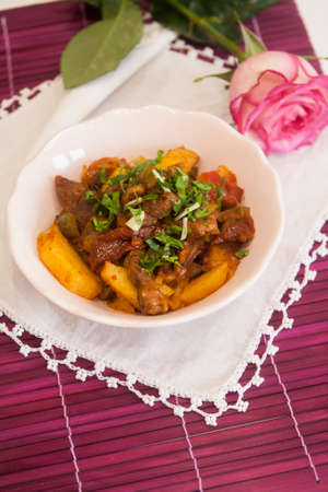 Meat stew with potatoes and spices, tomatoes, cucumbers and greens. Goulashの写真素材