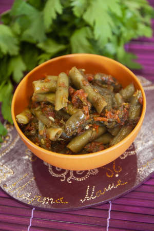 Salad with green beans in tomato sauce - paprika, parsley, dill - modern lean cuisineの写真素材