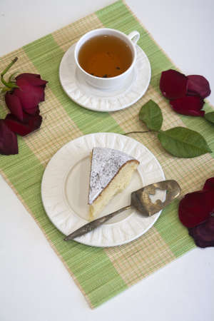 Morning biscuit cake with cup of tea on whiteの写真素材