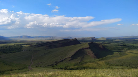 High autumn hills and mountains, foggy horizon with clouds - horizontal landscape photographyの写真素材