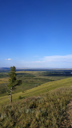 High autumn hills and mountains, foggy horizon with clouds - horizontal landscape photographyの写真素材