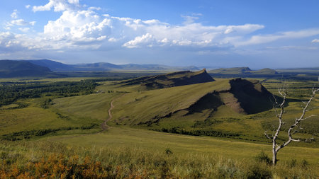 High autumn hills and mountains, foggy horizon with clouds - horizontal landscape photographyの写真素材