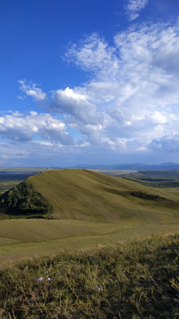 High autumn hills and mountains, foggy horizon with clouds - horizontal landscape photographyの写真素材