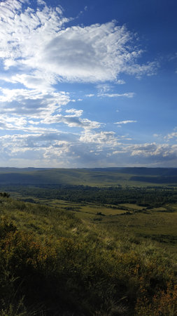 High autumn hills and mountains, foggy horizon with clouds - horizontal landscape photographyの写真素材