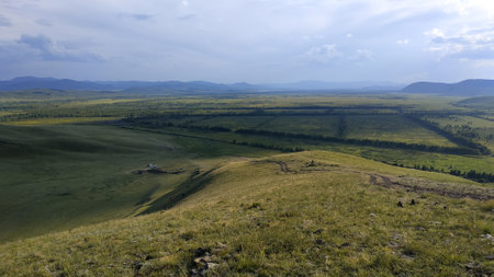 High autumn hills and mountains, foggy horizon with clouds - horizontal landscape photographyの写真素材