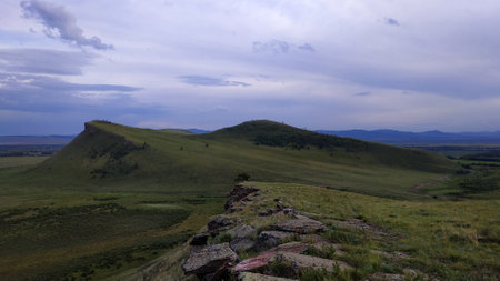 High autumn hills and mountains, foggy horizon with clouds - horizontal landscape photographyの写真素材