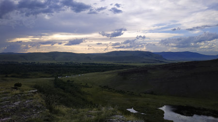 High autumn hills and mountains, foggy horizon with clouds - horizontal landscape photographyの写真素材