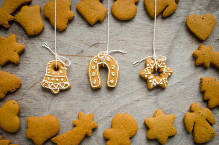 Christmas cookies set on wood rustic background. Bell, star and horseshoe cookie shapes in centre. Horizontal orientationの写真素材