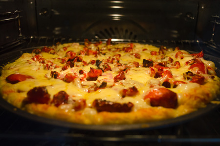 Pizza baking in ovenの写真素材