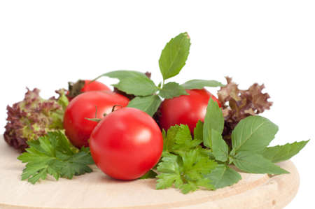 fresh red tomatoes and green parsley on white backgroundの写真素材